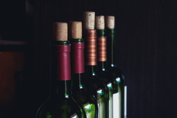Close up of opened wine bottles ready to serve.