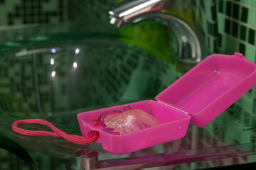 Pink removable braces 
in the case over the bathroom sink