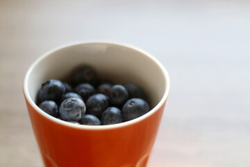 Bowl of blueberries on a table. Selective focus.