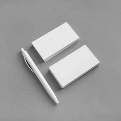 White stationery set. Business brand template on gray paper background. Blank business cards and pen.