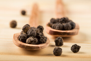 Pimenta do Reino. Black pepper on wooden background.