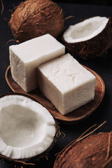 Coconut handmade soap and coco on dark concrete background