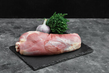 raw three beef steaks on a cutting board with spices on a stone background