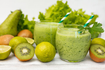 Healthy dieting and nutrition, food and drink, vegan, vegetarian concept, healthy lifestyle. Green smoothie with organic ingredients, vegetables on a wooden table 