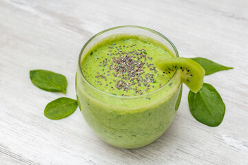 Healthy dieting and nutrition, food and drink, vegan, vegetarian concept, healthy lifestyle. Green smoothie with organic ingredients, vegetables on a wooden table 