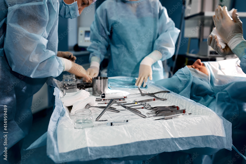 Aufkleber close up surgeons hand taking scissors, forceps and surgical instruments on table for operation with
