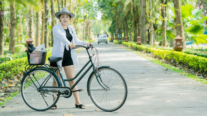 Fototapeta premium Young women, tourists, cycling in Sathan Park.