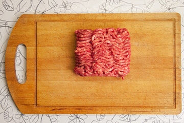 Ground beef on an old kitchen chopping board