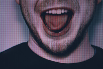 Young man  shows a tongue close up. Macro photography view. Close-up of pixel.