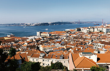 Fototapeta na wymiar A panoramic view over Lisbon with beautiful reed roofs and river Tejo in summer sunlight.