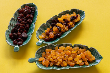 leaf-shaped ceramic pots with dark, light and mustured raisins.