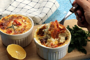 Cod casserole with cheese, sour cream and tomatoes. White fish casserole with cheese and sour cream, Baked fish on pot. Julienne of seafood