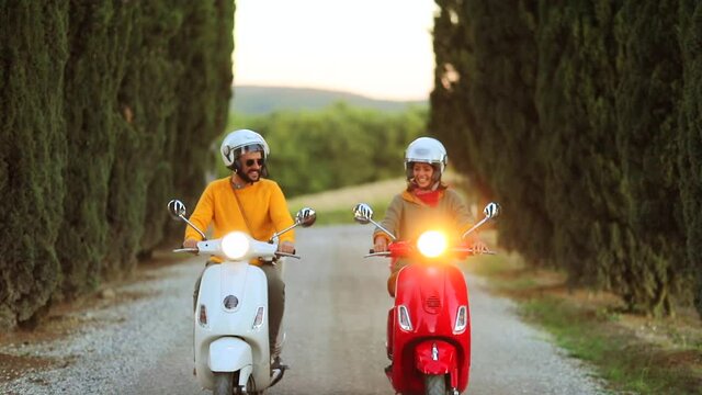 slow motion footage of young couple  on scooter enjoying in romantic road trip. 