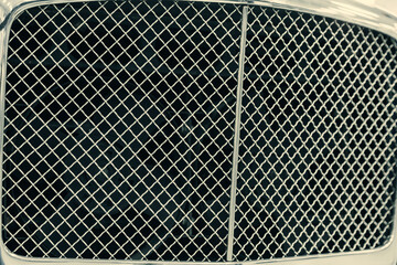 metal dark grille in the bumper of a modern car