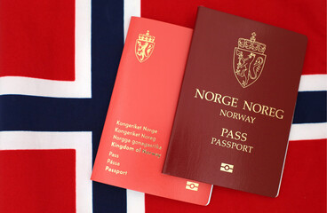 Drammen, Norway - January 2 2021 - Norwegian passports (New and Old design) on Norway flag.