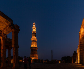 Qutub Minar a highest minaret in India standing 73 m tall tapering tower of five storeys made of...