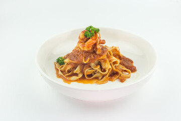 Pasta Fettuccine Bolognese with tomato sauce and prawns in white plate on white background