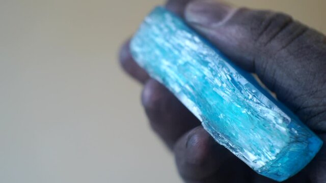 dirty man's hand holding a large crystal.close-up.shallow depth of field