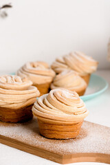 cruffins easter spring pastries, a mix of muffin and croissant on a light background, close-up for text place