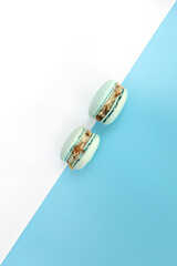 Tasty blue french macarons or macaroons on a white and blue background. Place for text. color geometry