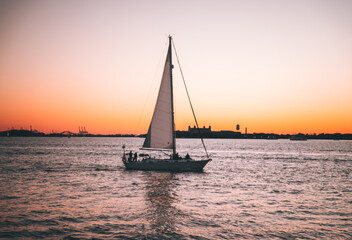 Fototapeta na wymiar boat sailboat sunset sea sky orange summer usa lovely vacation people