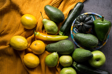 Still life with fresh organic vegetables and fruits. Yellow textured background. Healthy eating concept. 