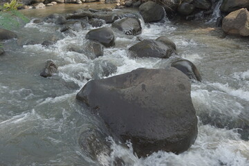 Big rock on the river with a natural background