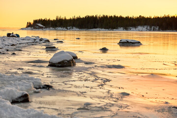 Fototapeta na wymiar Frozen lake at sunset in winter