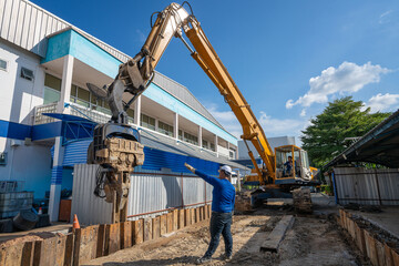 diesel hammer machine driving retaining wall steel sheet pile for the protection underground...