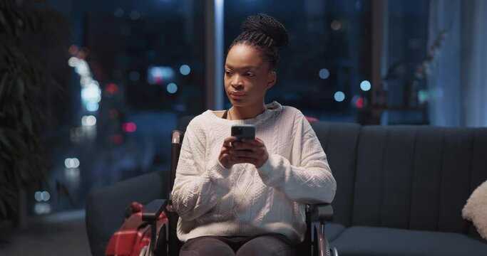Young beautiful casual african woman using mobile phone social media apps texdting messages staying home alone. Living room.Disabled person.