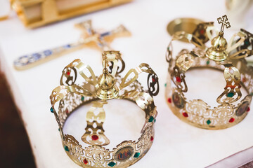Golden crowns lying on the table in church