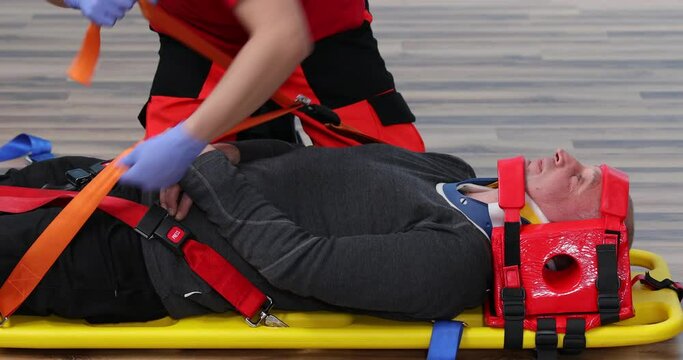 Patient on stretcher in EMS training emergency rescue situation, Paramedic Training. CPR medical training lies on a stretcher