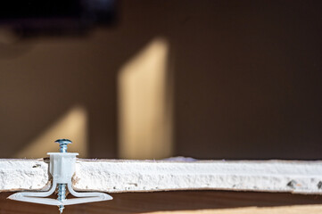 Side view of a drywall mount anchor and screw © Lost_in_the_Midwest