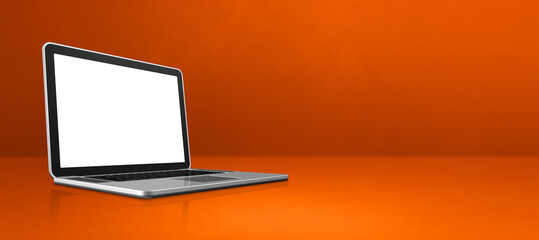 Laptop computer on orange office scene background banner