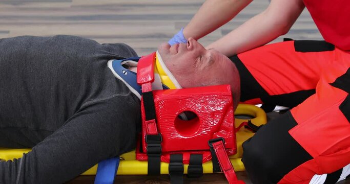 Patient on stretcher in EMS training emergency rescue situation, Paramedic Training. CPR medical training lies on a stretcher