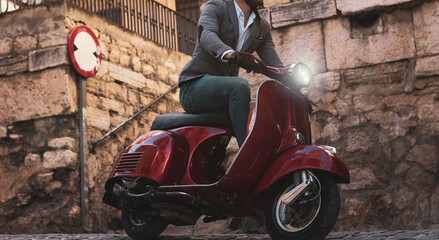 stylish young man driving a red motorcycle