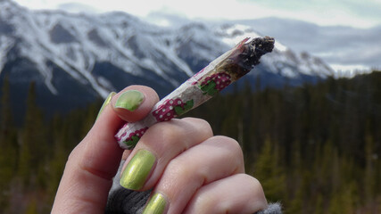A Joint wrapped in pink leaf patterned rolling paper 
