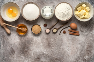 Baking background. Baking ingredients: flour, eggs, sugar, butter, milk and spices. Top view.