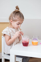 Art activities for kids. Child blow into the glass with colours.