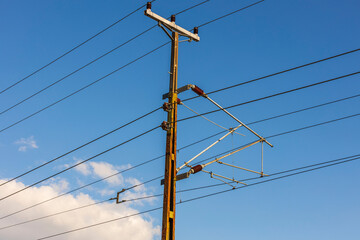 Close up view of power line on blue sky and white clouds background.