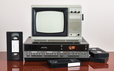 Fototapeta na wymiar Old silver vintage TV with VCR on wallpaper background.
