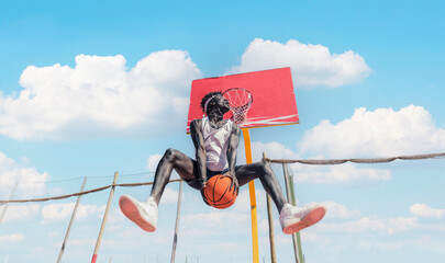 Basketball street player making a rear slam dunk	