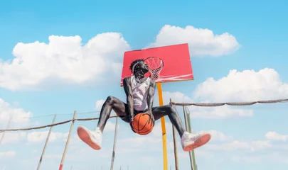 Fotobehang Basketball street player making a rear slam dunk  © Davide Angelini
