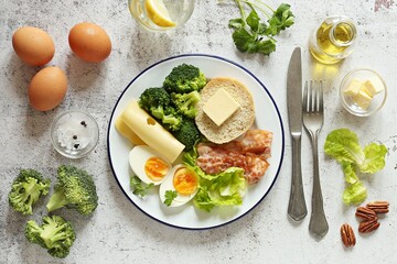 Low carb breakfast with egg, fried bacon, broccoli and gluten free keto bread. Flat layot, copy space
