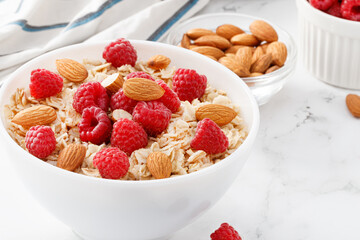 bowl of oatmeal with raspberries and almonds
