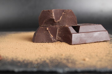 macro day chocolate two large chopped pieces of chocolate on a black background close-up