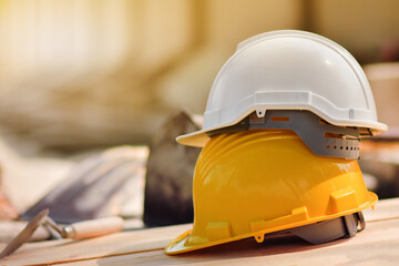 Yellow helmet hard hat  on wood floor in constriction site