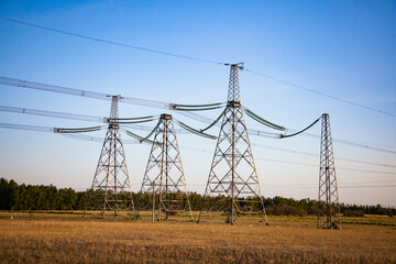 High-voltage transmission line and electric towers on beauty landscape and sky at sunset. 