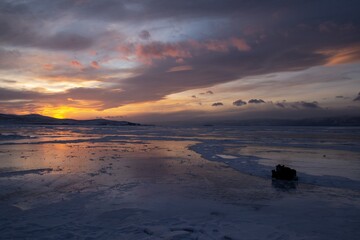 sunset over the frozen lake