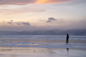 silhouette of a person on the frozen lake 